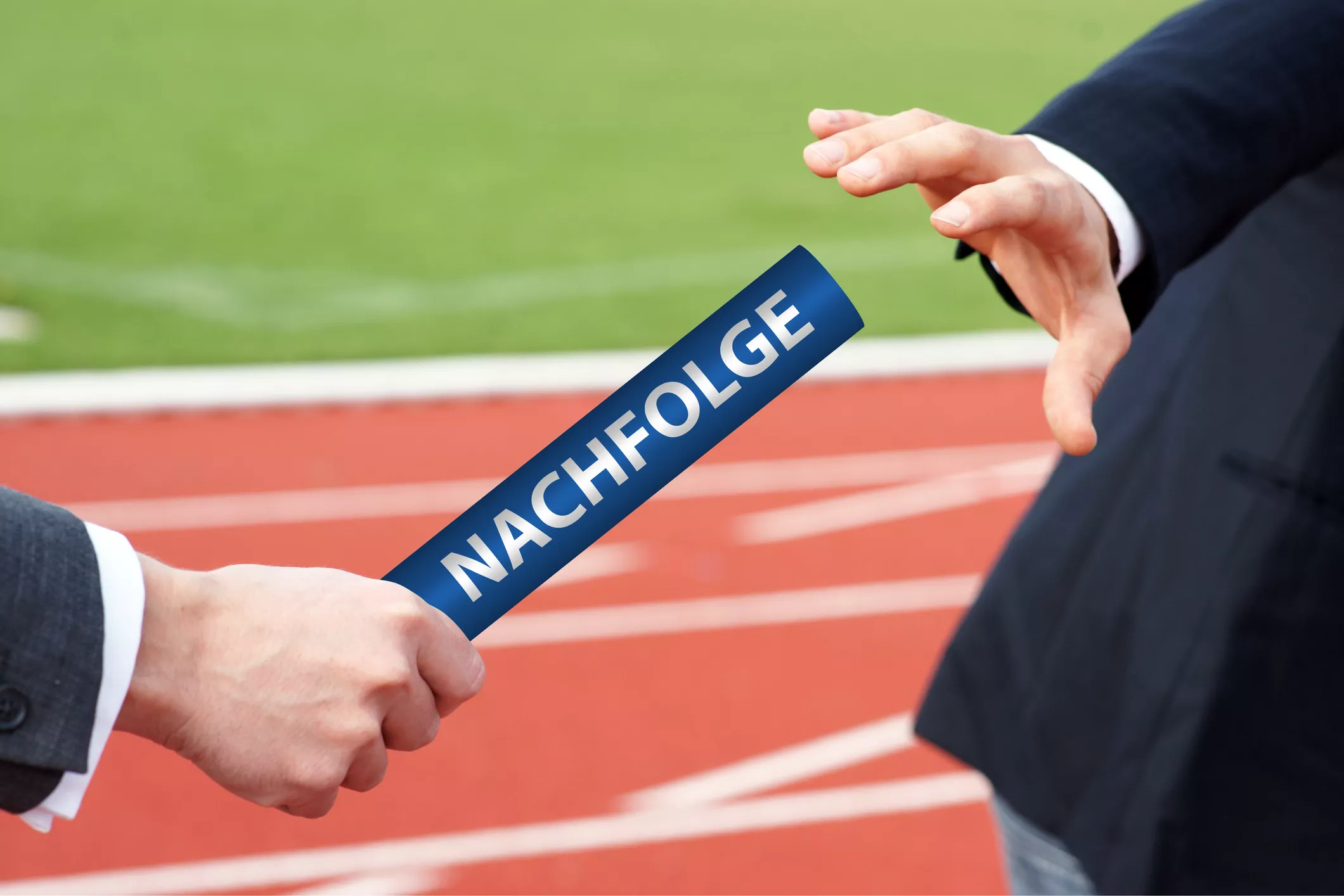 businessmen-passing-blue-baton-in-relay-race-with-german-word-nachfolge-which-means-succession-1198898462-2124x1416
