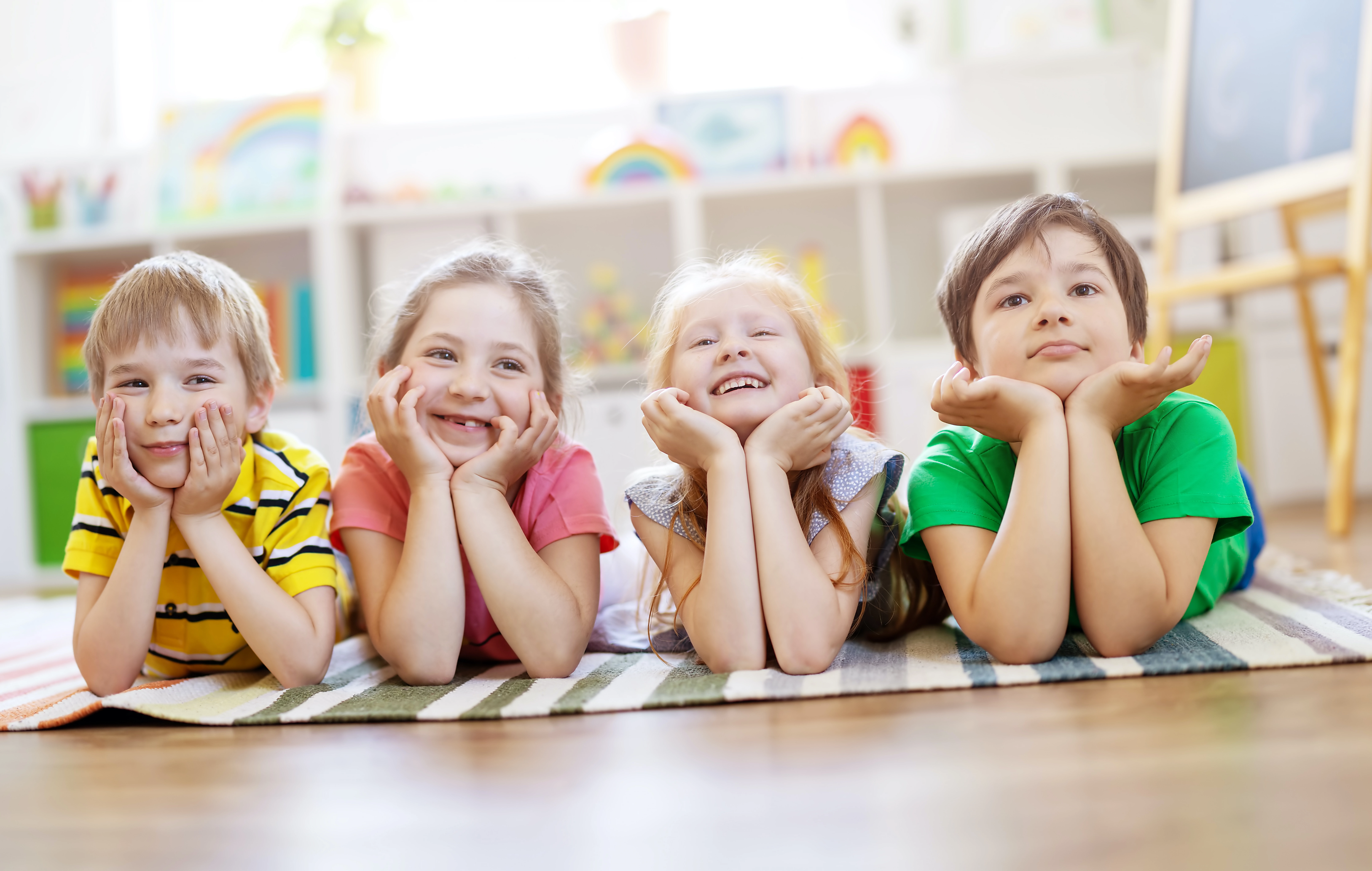 group-of-children-lying-on-the-floor-and-looking-in-the-camera-1343622466-7584x3674.80.647883af418a6